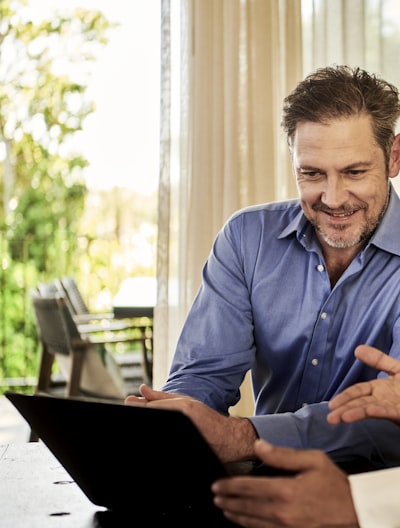 man smiling looking at a tablet